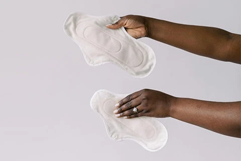 Close up of a woman holding two hannahpads up