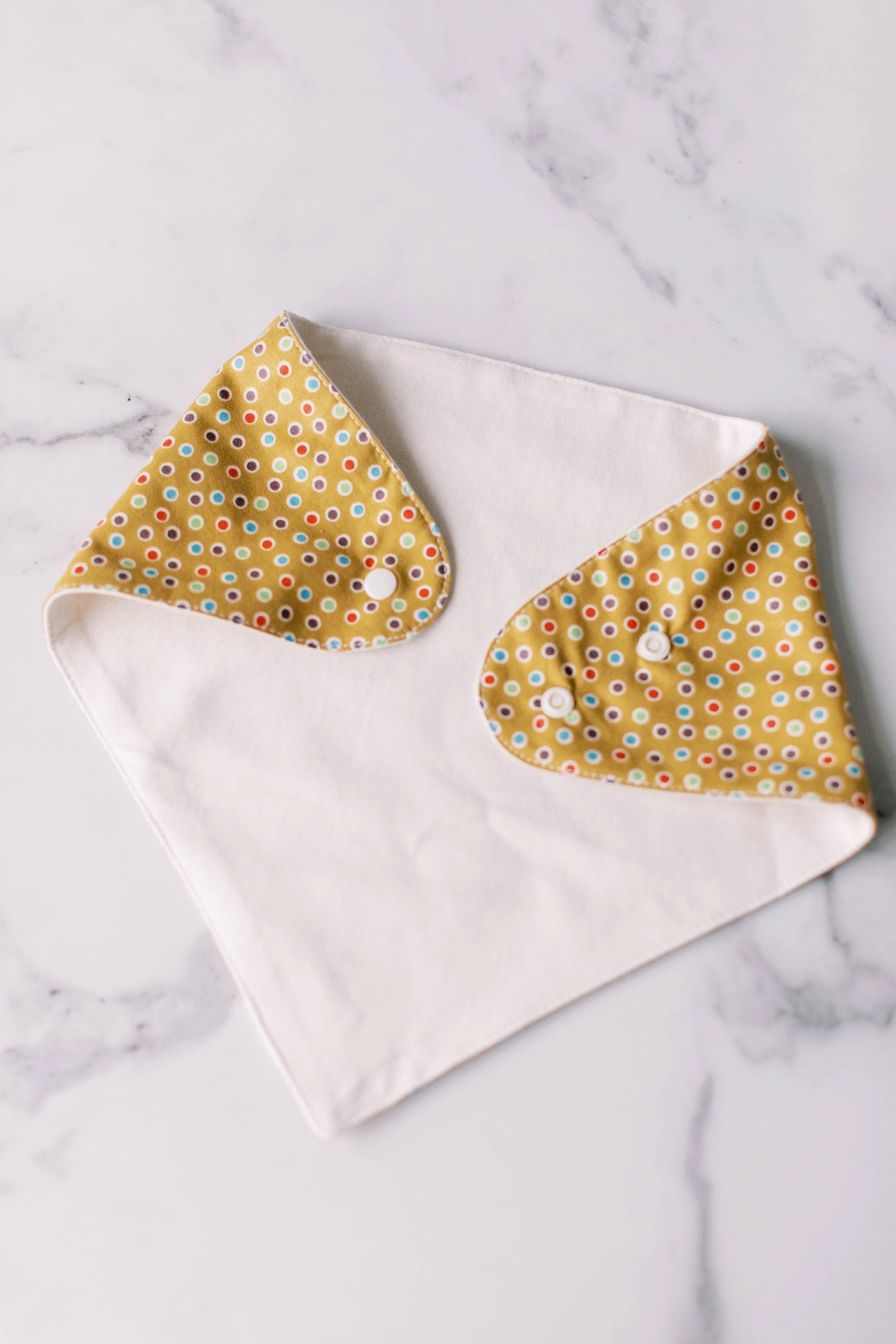 hannahBEBE scarf bib folded showing 2 snaps