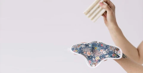  Cropped photo of a woman holding a hannahpad along with a bar of laundry soap