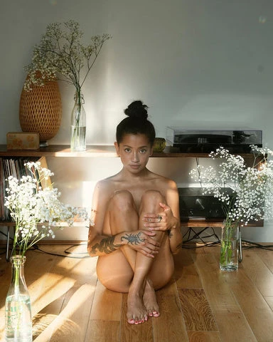 Bianca Venerayan posing in the nude surrounded by flowers