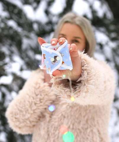 Woman posing in the winter snow with a folded hannahpad